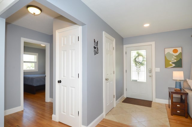 foyer with baseboards, recessed lighting, and light wood finished floors