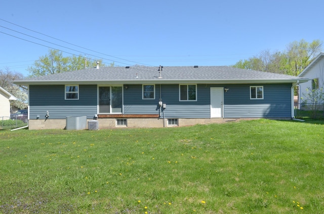 rear view of house featuring a yard and cooling unit