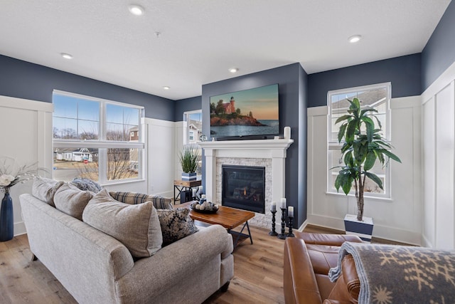 6921 Huckleberry Dr, Minnetrista, MN 55331 - living area with a fireplace, wood finished floors, and a decorative wall