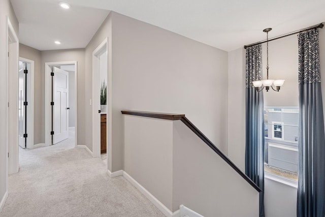 6921 Huckleberry Dr, Minnetrista, MN 55331 - corridor featuring an upstairs landing, a chandelier, light carpet, and recessed lighting