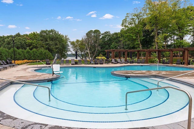 6921 Huckleberry Dr, Minnetrista, MN 55331 - community pool featuring a pergola, a patio area, and view of wooded area