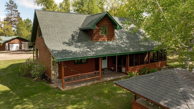 33507 Old 371, Pequot Lakes, MN 56472 - back of property with a garage, a shingled roof, a lawn, faux log siding, and an outbuilding