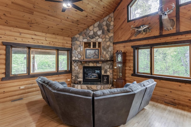 33507 Old 371, Pequot Lakes, MN 56472 - living area with plenty of natural light, light wood-type flooring, high vaulted ceiling, a fireplace, and a ceiling fan