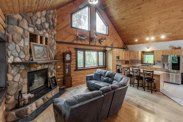 33507 Old 371, Pequot Lakes, MN 56472 - living room with high vaulted ceiling, wooden ceiling, a fireplace, light wood-style floors, and ceiling fan