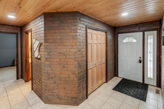 33507 Old 371, Pequot Lakes, MN 56472 - entrance foyer featuring wood ceiling, light tile patterned flooring, wood walls, and brick wall