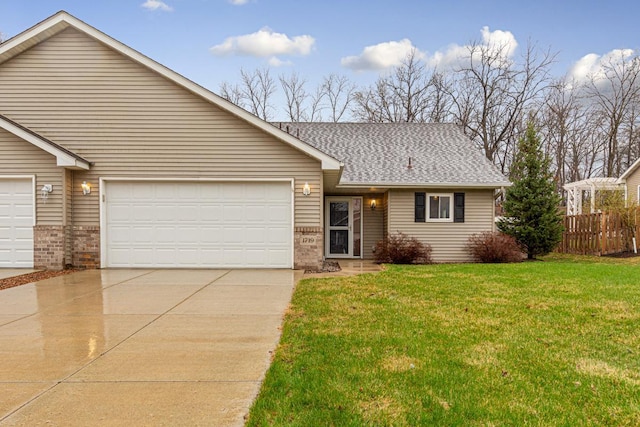 ranch-style home featuring a garage, driveway, a shingled roof, a front yard, and brick siding