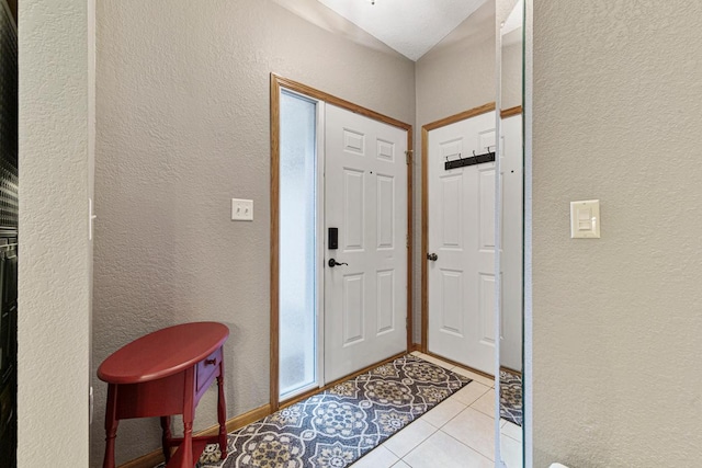 tiled foyer entrance featuring a textured wall