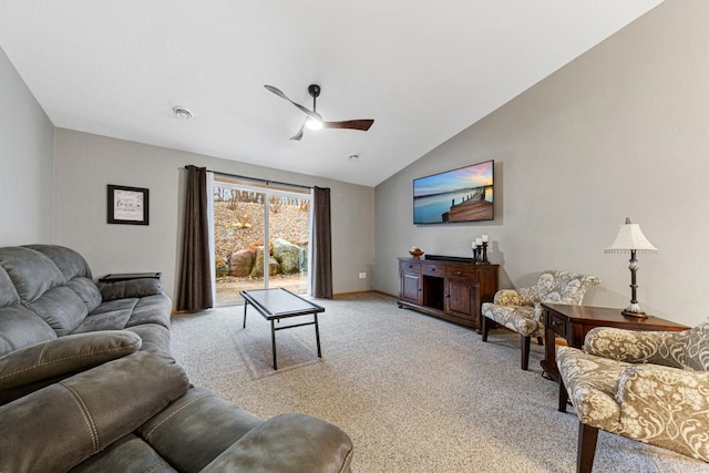 living area with baseboards, lofted ceiling, light colored carpet, and ceiling fan