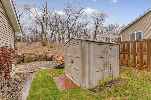 view of shed featuring fence