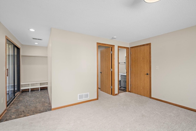 unfurnished bedroom with visible vents, carpet, and baseboards