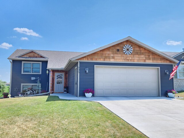 view of front of home featuring a garage, roof with shingles, concrete driveway, and a front lawn