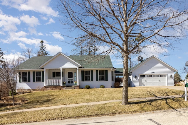view of front of home featuring roof with shingles, a front lawn, an outbuilding, concrete driveway, and covered porch