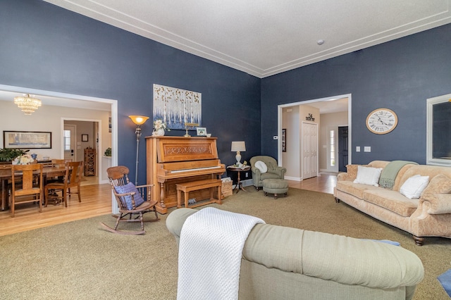 living room featuring a high ceiling, an inviting chandelier, wood finished floors, and carpet