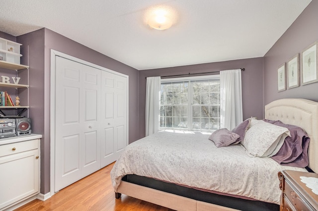 bedroom with a closet and light wood-style flooring