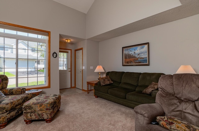 living room featuring carpet floors and high vaulted ceiling