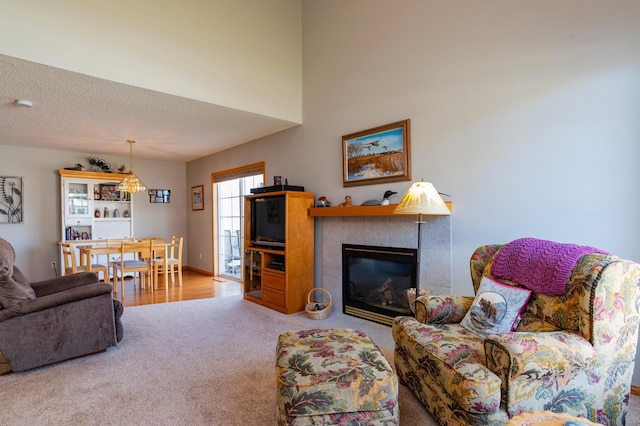 carpeted living room with a tile fireplace