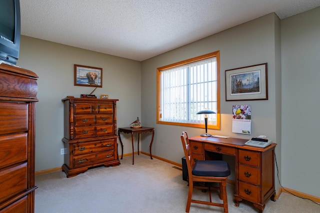 home office featuring a textured ceiling, light carpet, and baseboards