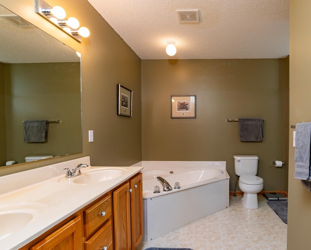 bathroom featuring a sink, toilet, a textured ceiling, visible vents, and a garden tub