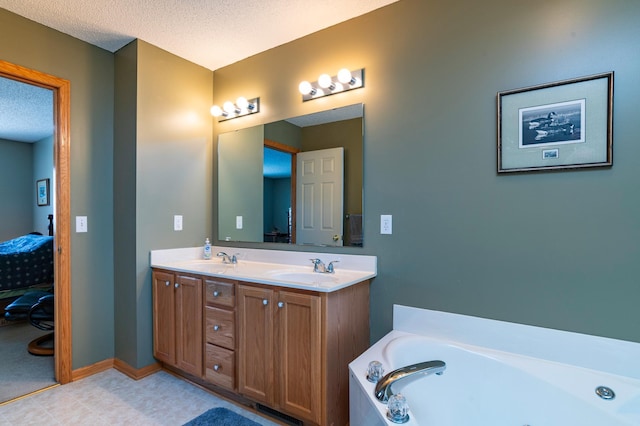 ensuite bathroom featuring double vanity, a garden tub, a sink, a textured ceiling, and ensuite bathroom