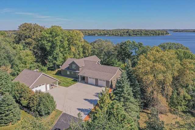 aerial view with a wooded view and a water view