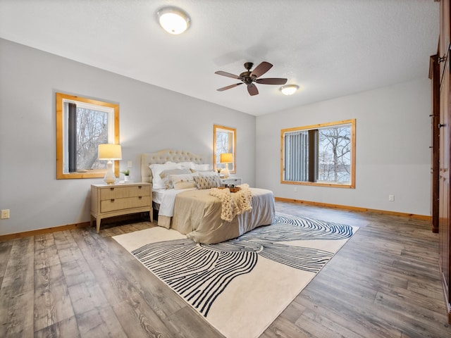 bedroom with baseboards and wood finished floors