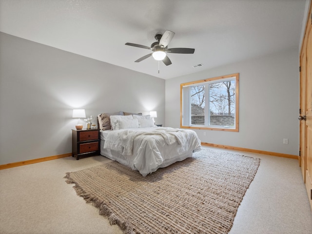bedroom with visible vents, light carpet, baseboards, and ceiling fan