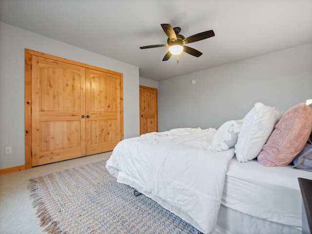 bedroom with a ceiling fan, baseboards, and light colored carpet