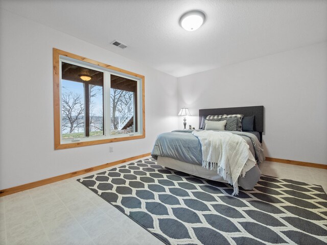 bedroom with baseboards and visible vents