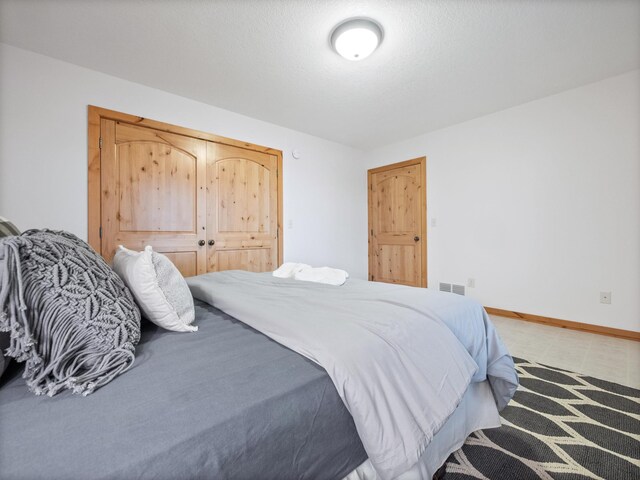 bedroom with visible vents and baseboards