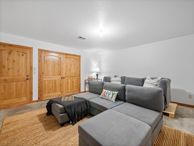 home theater featuring baseboards, a textured ceiling, and visible vents