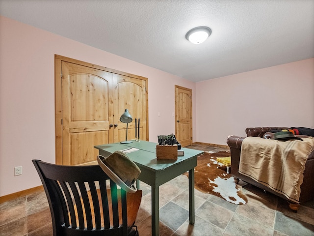 office with baseboards and a textured ceiling