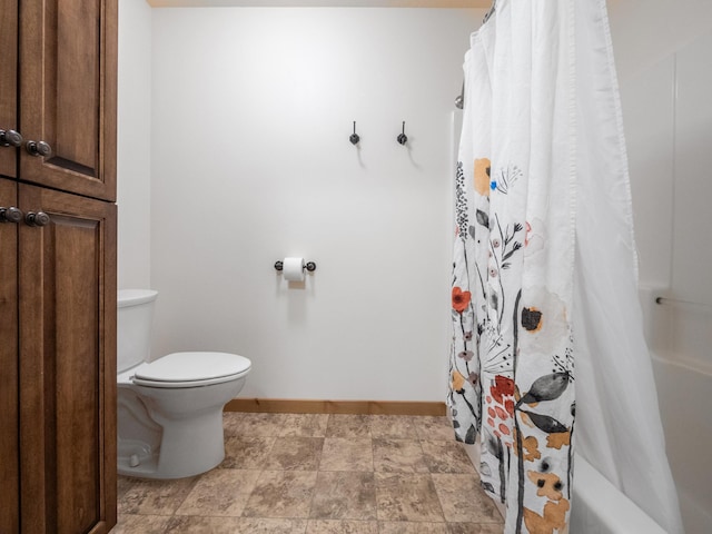 bathroom featuring toilet and baseboards