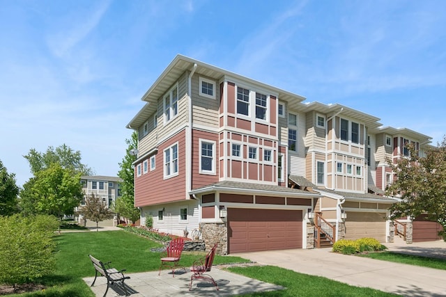 view of front facade with a garage, a front lawn, driveway, and stone siding