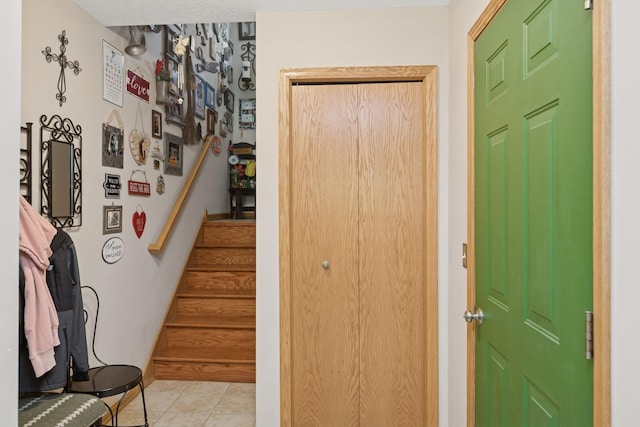 stairs featuring tile patterned flooring