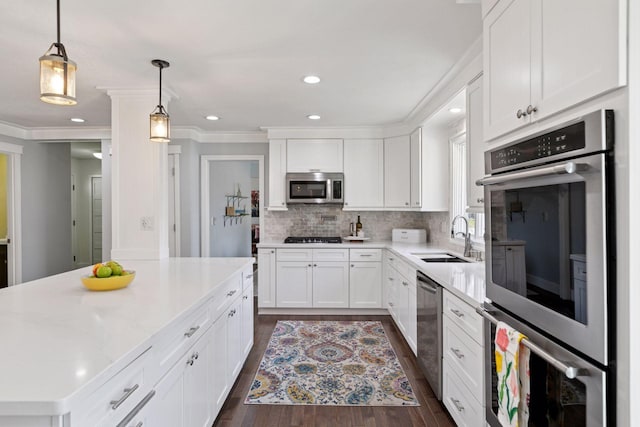 kitchen featuring light countertops, a sink, white cabinetry, and appliances with stainless steel finishes