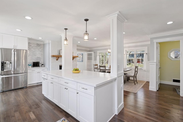 kitchen featuring dark wood finished floors, light countertops, ornamental molding, stainless steel fridge, and white cabinetry