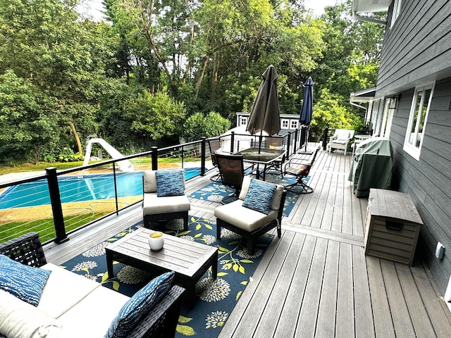 deck with an outdoor pool and outdoor dining area