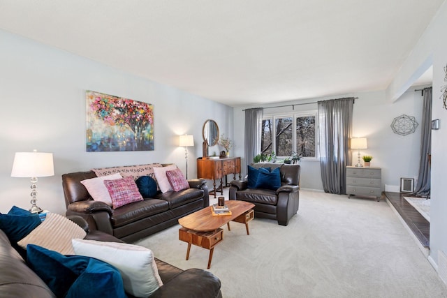 living area with baseboards and light colored carpet