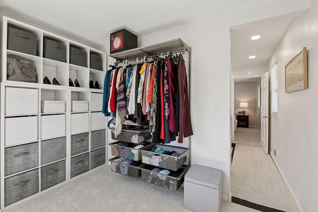 walk in closet with carpet floors