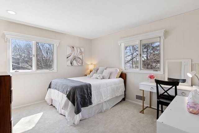 bedroom with light colored carpet, baseboards, and visible vents
