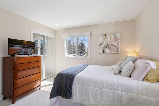 bedroom featuring a closet and light colored carpet