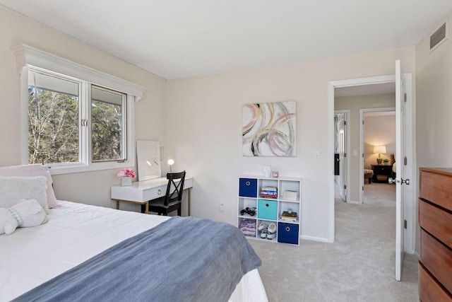 carpeted bedroom with visible vents and baseboards