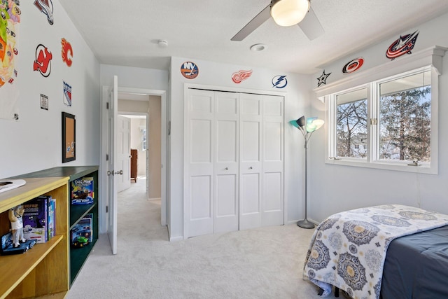 bedroom featuring a closet, carpet flooring, and a ceiling fan