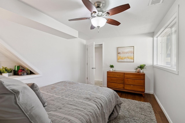 bedroom featuring dark wood finished floors, baseboards, a ceiling fan, and visible vents