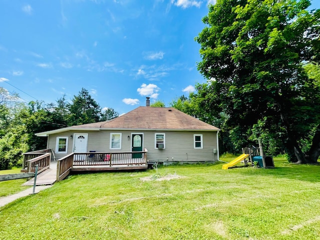 321 2nd Ave, Grand Rapids, MN 55744 - back of house with a deck, a lawn, a chimney, and a playground