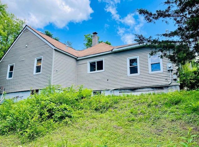 321 2nd Ave, Grand Rapids, MN 55744 - back of house featuring a chimney