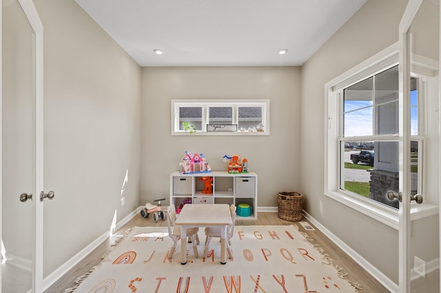 rec room with wood finished floors, recessed lighting, and baseboards