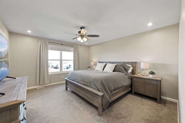 bedroom featuring light colored carpet, recessed lighting, baseboards, and a ceiling fan