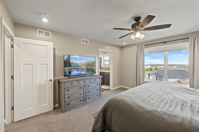 bedroom with a textured ceiling, light carpet, multiple windows, baseboards, and ceiling fan