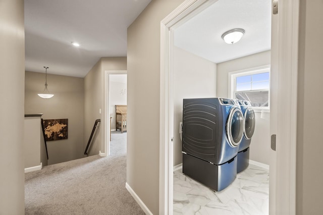 laundry room featuring washing machine and clothes dryer and baseboards